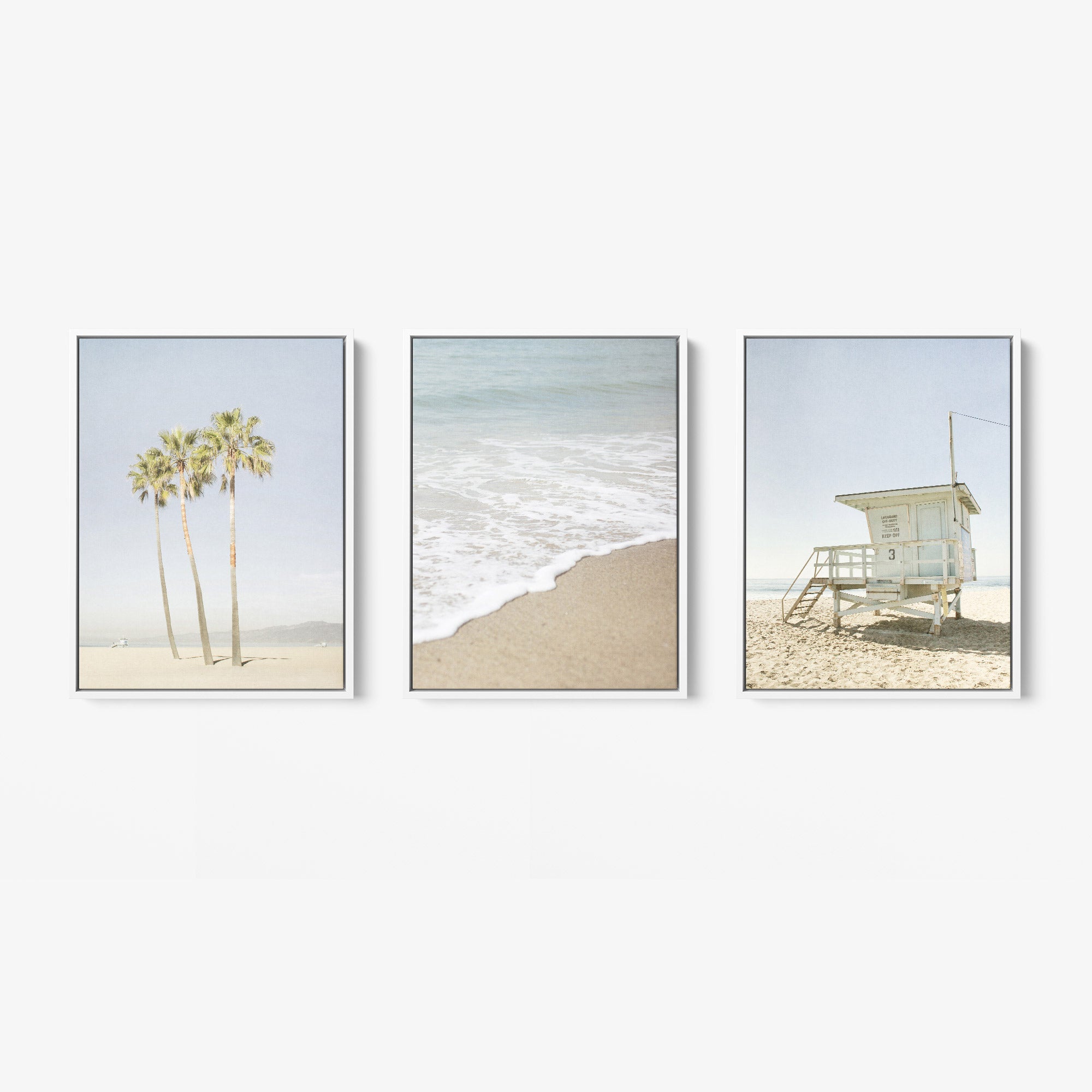 Offley Green&#39;s Set of 3 Framed Canvas offers multiple print choices: one with palm trees on a beach, another featuring ocean waves, and a third depicting a lifeguard tower. Crafted from FSC-certified renewable forests, each piece features coastal styles in soft, muted colors.