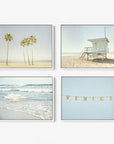 Introducing the Offley Green Set of 4 Framed Canvas prints. This collection includes a variety of designs, such as: 
- Top left: palm trees on a sandy beach capturing coastal vibes,
- Top right: a lifeguard tower standing on the shoreline,
- Bottom left: ocean waves gently approaching the shore,
- Bottom right: "Venice" illuminated with string lights against a clear sky.

Choose from multiple combinations to personalize your space.