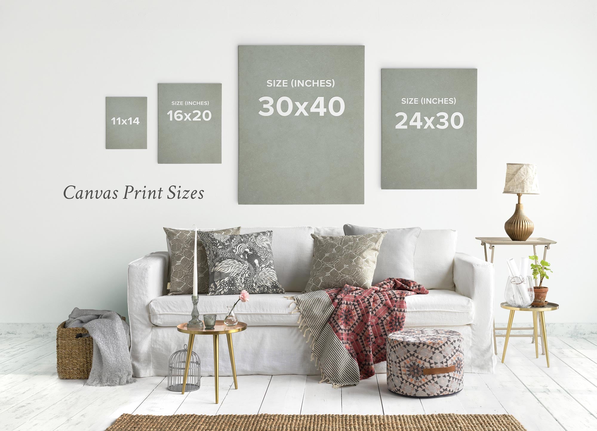 The living room showcases a white sofa with decorative pillows, a patterned throw, and a pouf, complemented by Offley Green&#39;s responsibly-sourced Set of 3 Canvas prints. Displayed in various sizes, these premium artist-grade prints add character to the space.