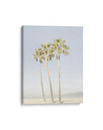 Offley Green's Set of 3 Canvas features a minimalist design with three tall palm trees on a sandy beach and a distant boat beneath a light blue sky. Made from FSC-certified materials, it's both beautiful and eco-friendly.