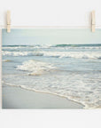 A photograph of Carlsbad State Beach showing waves and shoreline, pinned by wooden clothespins on a string against a white wall. 
Product Name: Offley Green Coastal Beach Print in California 'Surf and Sun'