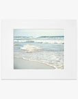 A photograph of Carlsbad State Beach, capturing the gentle waves lapping onto sandy shores, depicted in a simple white frame. This is the Offley Green Coastal Beach Print in California 'Surf and Sun'.