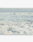 A serene ocean scene with gentle waves creating white foam as they approach the shore. The horizon is visible in the distance under a clear sky, blending with the calm sea. Ideal for coastal prints, Offley Green's 11x14 Coastal Canvas Print (Choose from 10+ Designs) is ready to hang and enhance any space with its tranquil beauty.