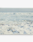 The 30x40 Coastal Canvas Print by Offley Green captures a serene image of ocean waves crashing gently onto the shore under a bright, clear sky. The white foam created by the waves is prominent in the foreground, while the horizon line blending into the sky forms a stunning backdrop for your wall art collection. Choose from over 10 designs to find the perfect coastal print for your space.