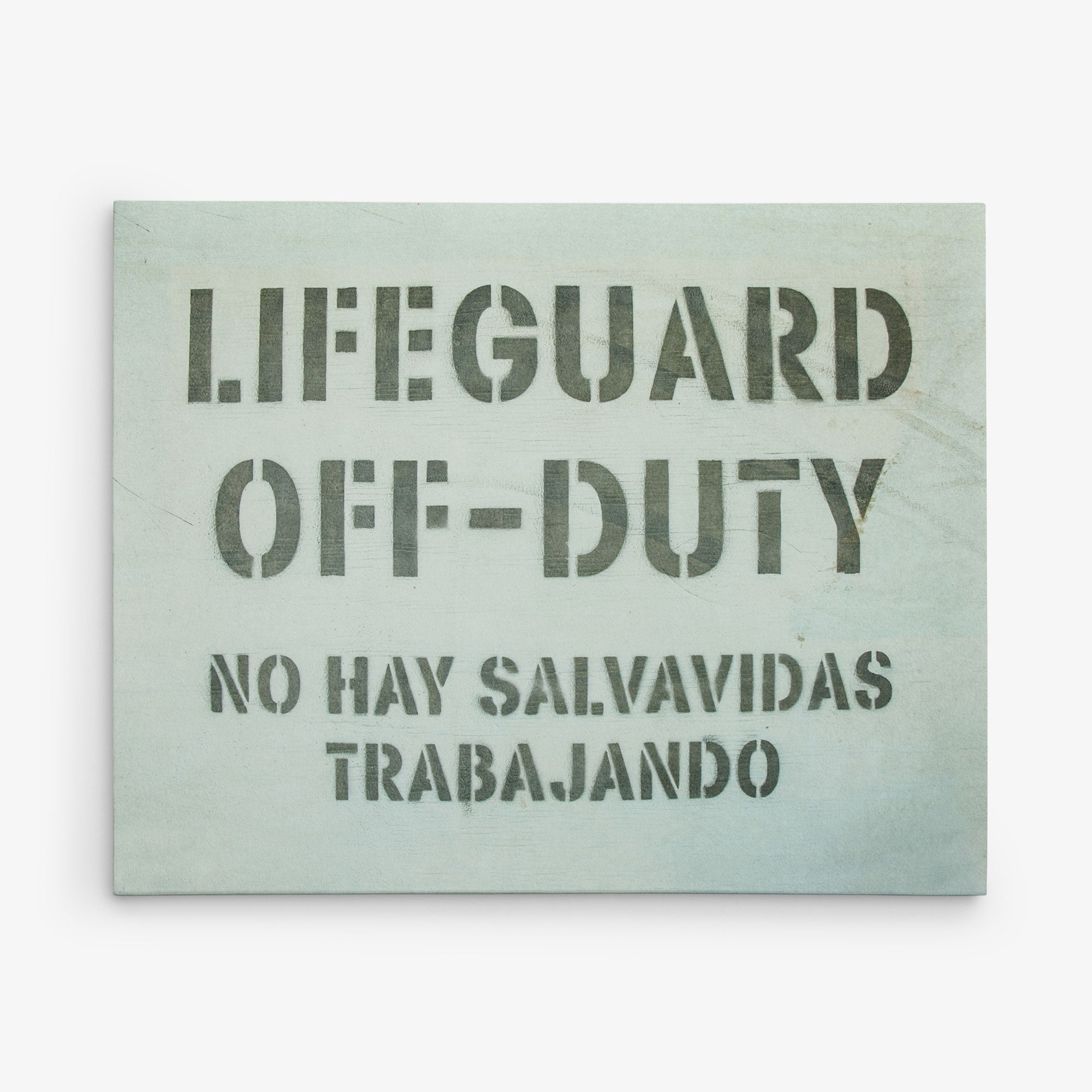 A sign displays the text &quot;LIFEGUARD OFF-DUTY&quot; in English and &quot;NO HAY SALVAVIDAS TRABAJANDO&quot; in Spanish, indicating that no lifeguard is on duty. The text is stenciled in black on a light-colored background, making it a striking piece of Offley Green&#39;s 30x40 California Canvas Print (Choose from 10+ Designs) wall art or an eye-catching canvas gallery wrap.