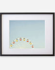 Offley Green's 'Ferris Blue' framed photograph of a ferris wheel against a clear sky at Santa Monica Pier, with the wheel seen from a side angle, displaying colorful passenger cabins. The frame is black with a white mat