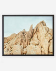 A framed photograph of a rugged, rocky landscape showcasing a cluster of large, weathered boulders under a clear sky in Joshua Tree.
Product Name: Offley Green's 'Joshua Rocks' Print