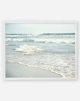 A framed photograph of a tranquil beach scene at Carlsbad State Beach, depicting gentle waves rolling onto the sandy shore under a clear sky, from Offley Green's Coastal Beach Print in California 'Surf and Sun'.