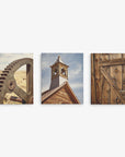 Offley Green offers a Set of 3 Canvas featuring a rusty gear against a barren landscape, a wooden building's steeple under a blue sky, and an old wooden door with metal hinges. Choose from multiple combinations for premium artist-grade displays.