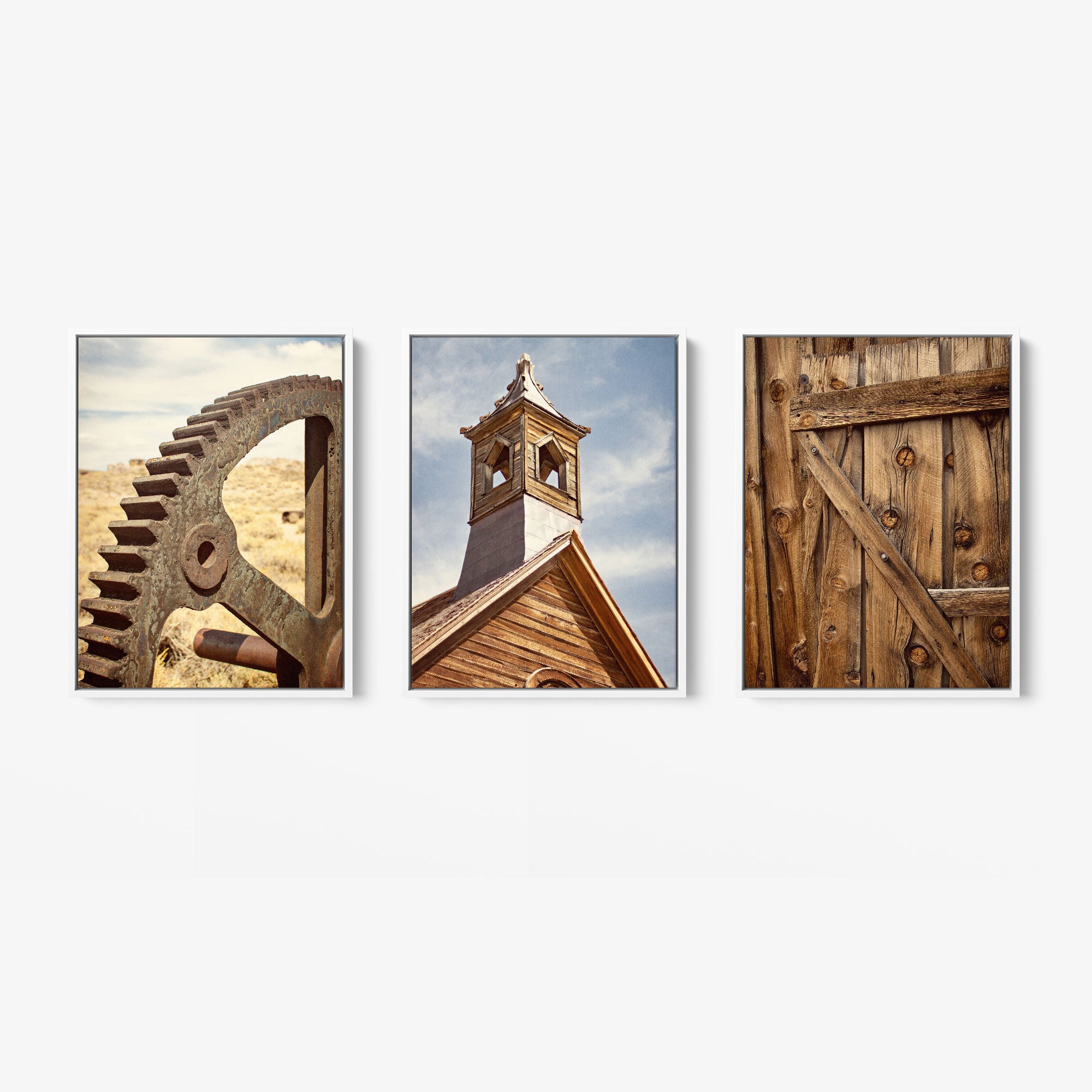 The Offley Green Set of 3 Framed Canvas features prints of a large rusted gear in a desert, a wooden church steeple under a blue sky, and an old wooden door with visible grain, blending botanical rustic coastal styles.