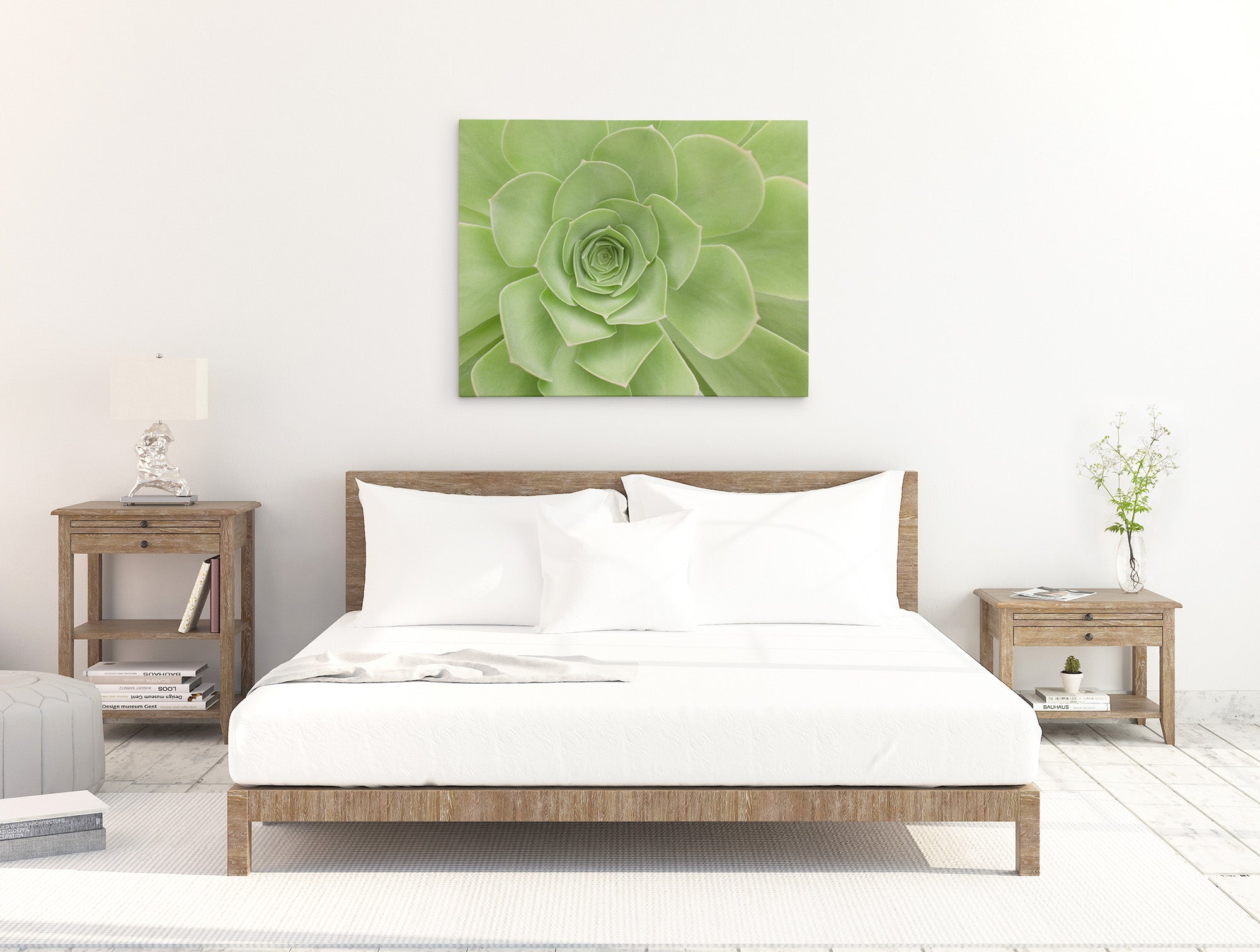 A minimalist bedroom features a wooden bed with white linens, flanked by two wooden nightstands. Each nightstand has a lamp and a small decorative item. Mounted above the bed is a stunning 30X40 Botanical Canvas Print (Choose from 10+ Designs) by Offley Green. The floor is white and carpeted.